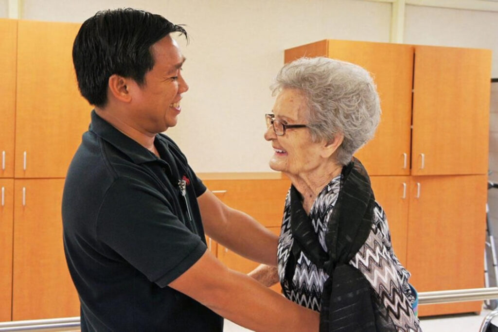 Caregiver provides friendly support to an older resident.