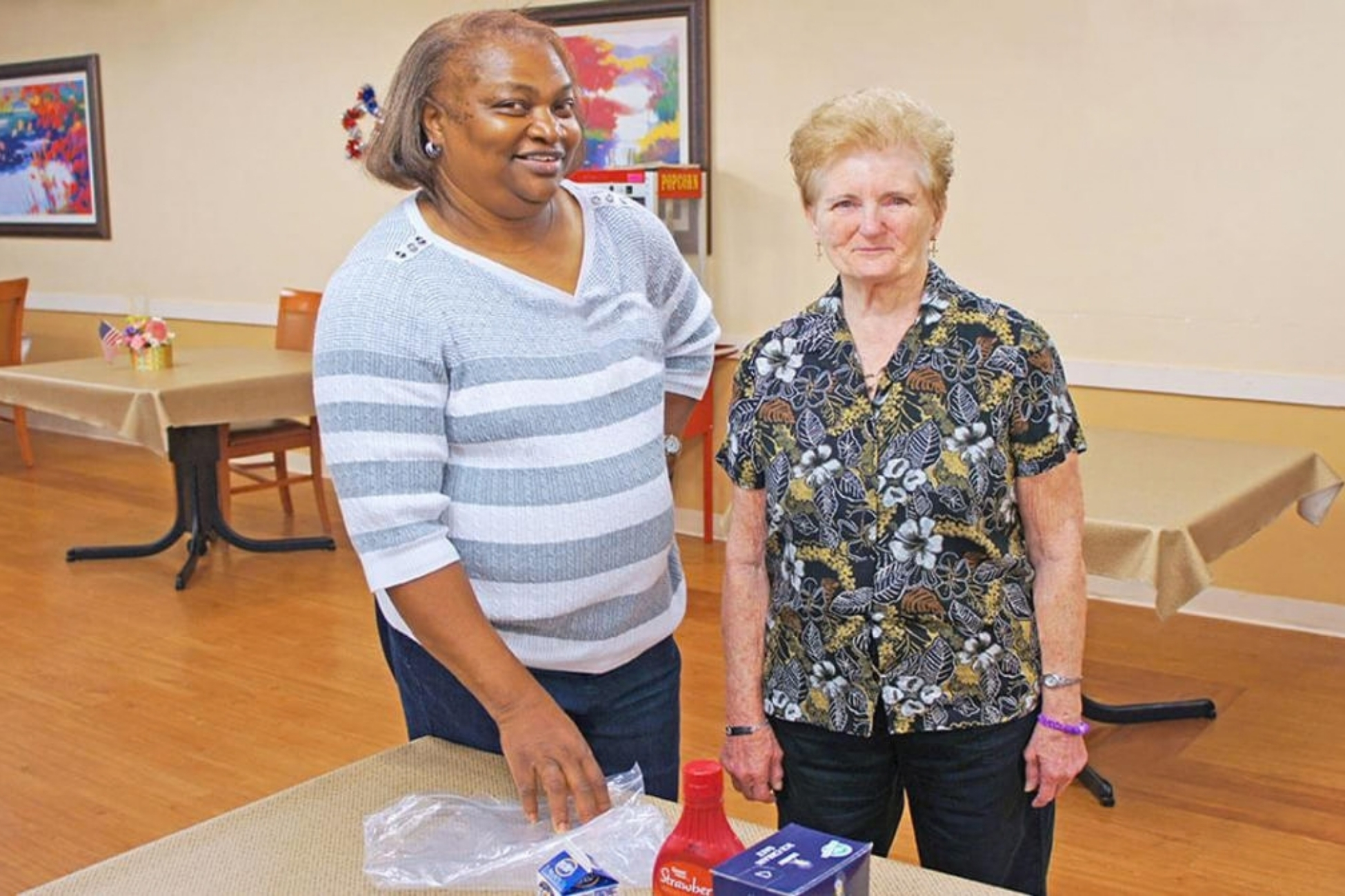 Staff member and resident participate in an indoor activity.