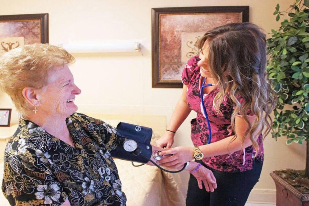 Nurse checks a resident’s blood pressure during skilled nursing care.