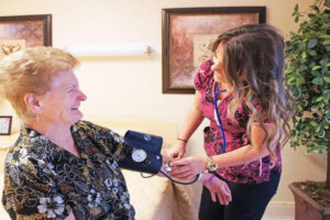 Nurse checks a resident’s blood pressure during skilled nursing care.